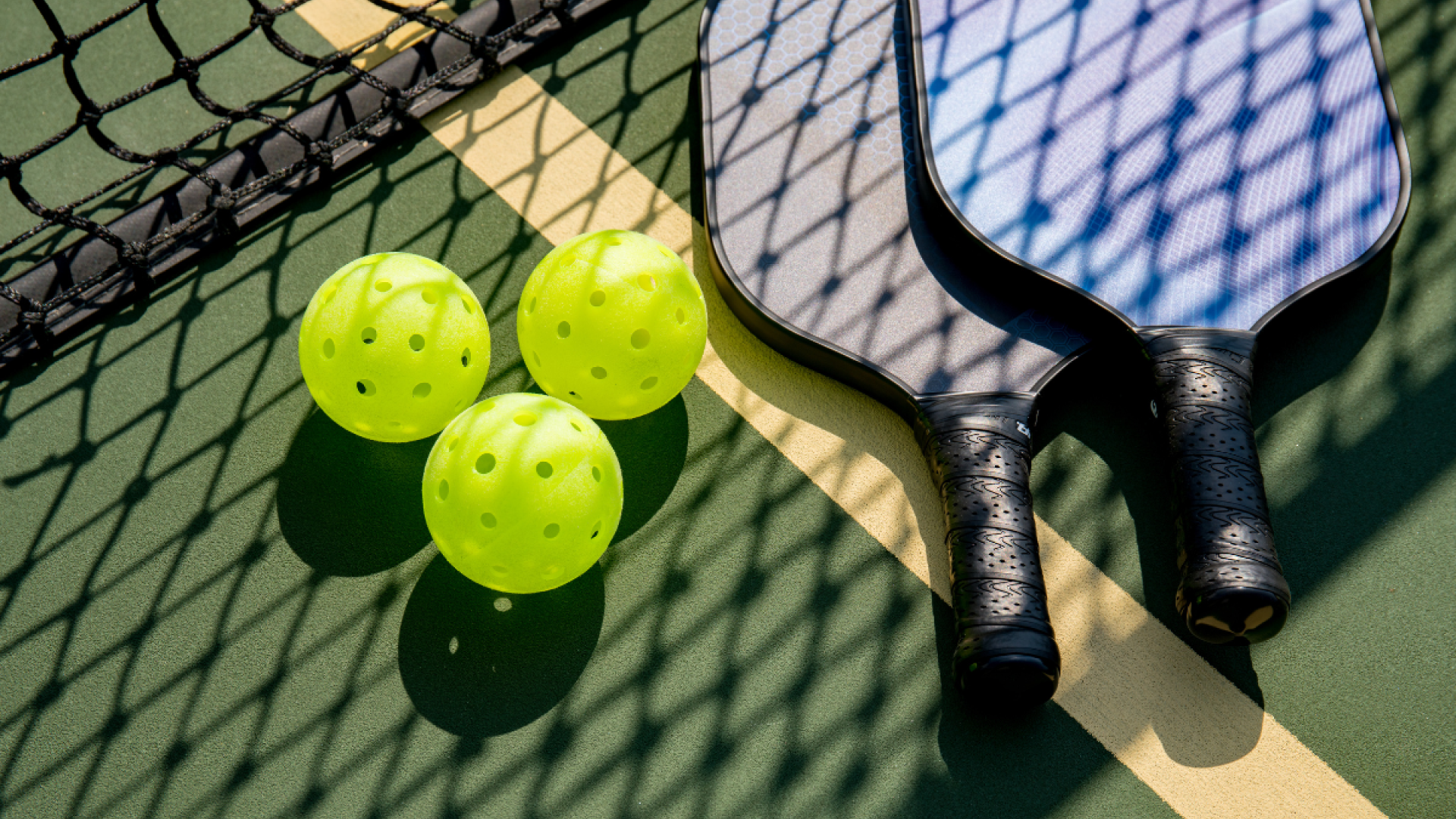 pickleball net, rackets, and balls