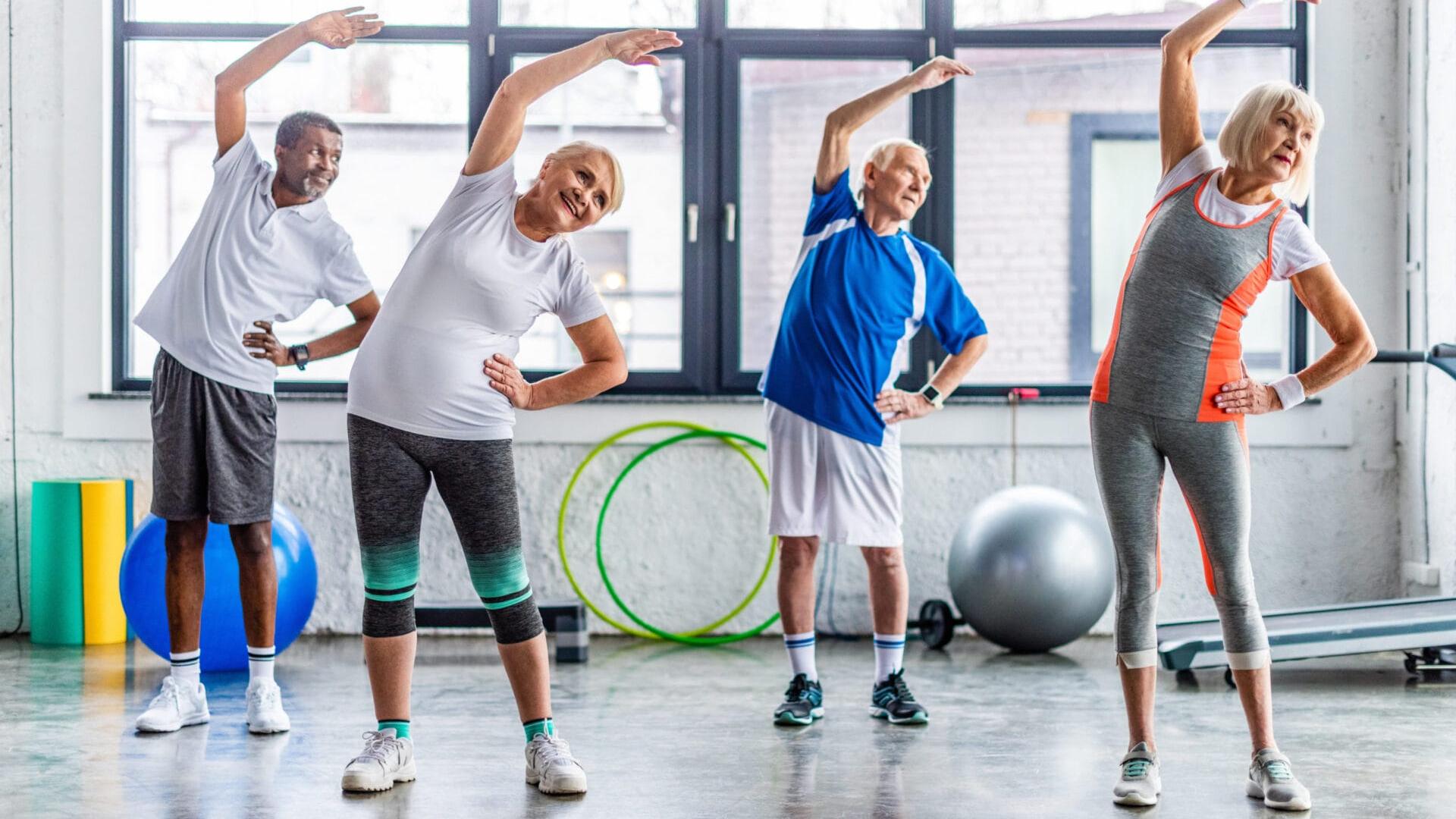 four adults stretching