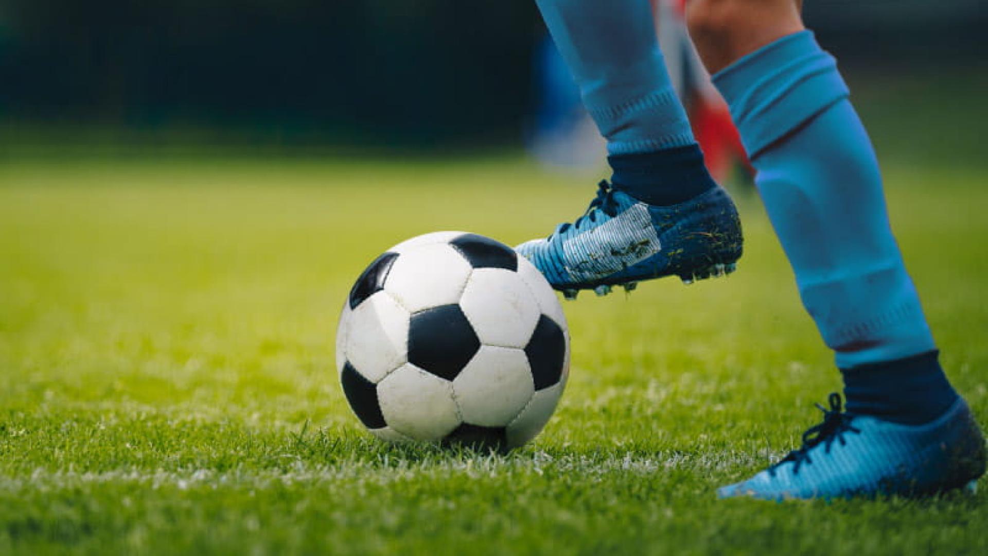 photo of someone kicking a soccer ball