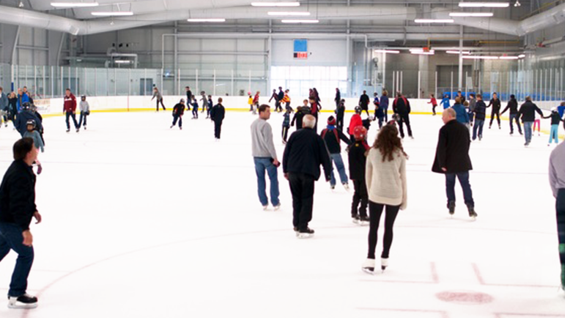 a group of people skating in an arena