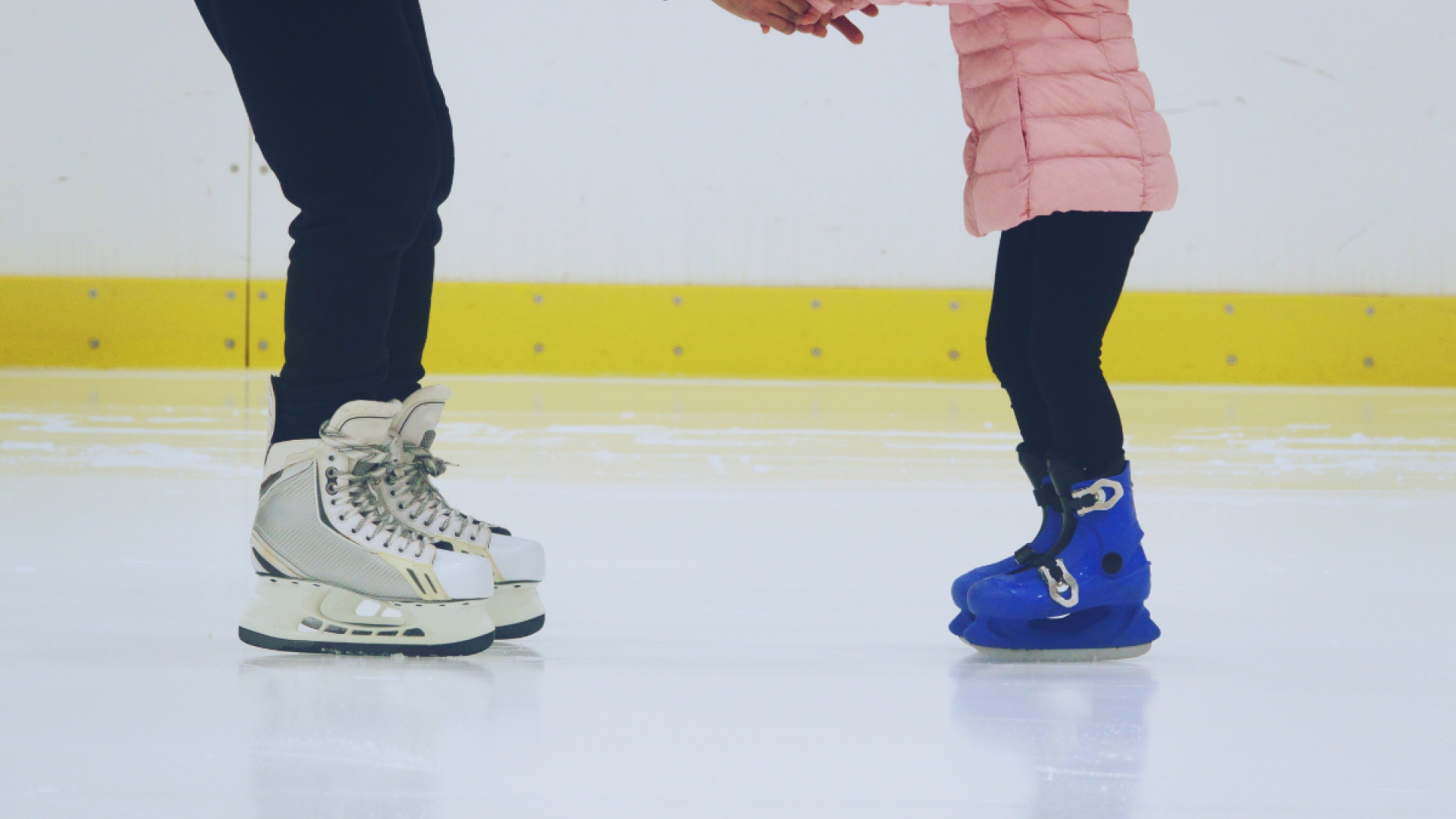 a photo of a parents skates and childrens skates