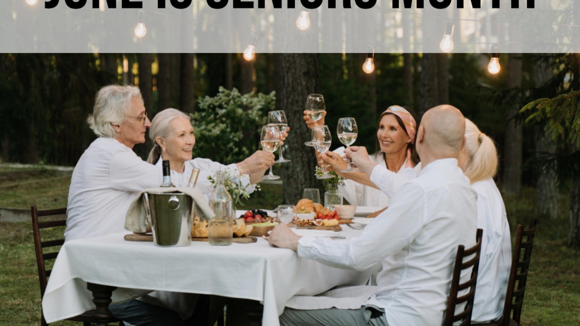A group of seniors around a table in the forest raising a toast with "June is Seniors Month" text in a banner on top.
